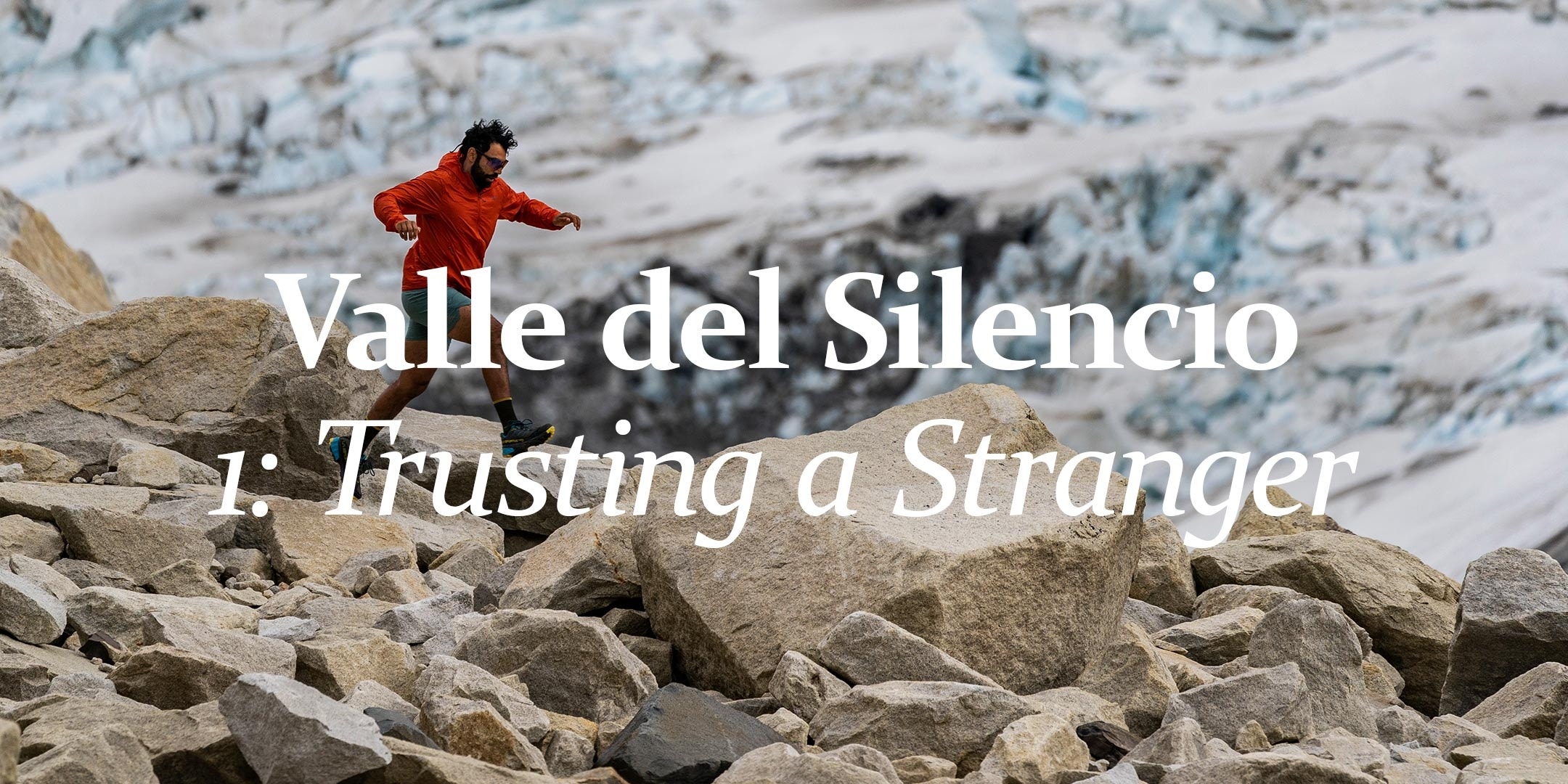 Felipe running and jumping across boulders in the Valle del Silencio, Patagonia, with a glacier in the background. 